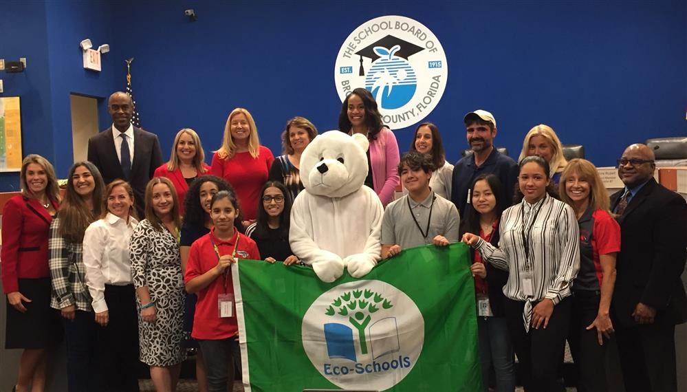 Ms. Gancitano, Mr. Williams and group posing with banner award